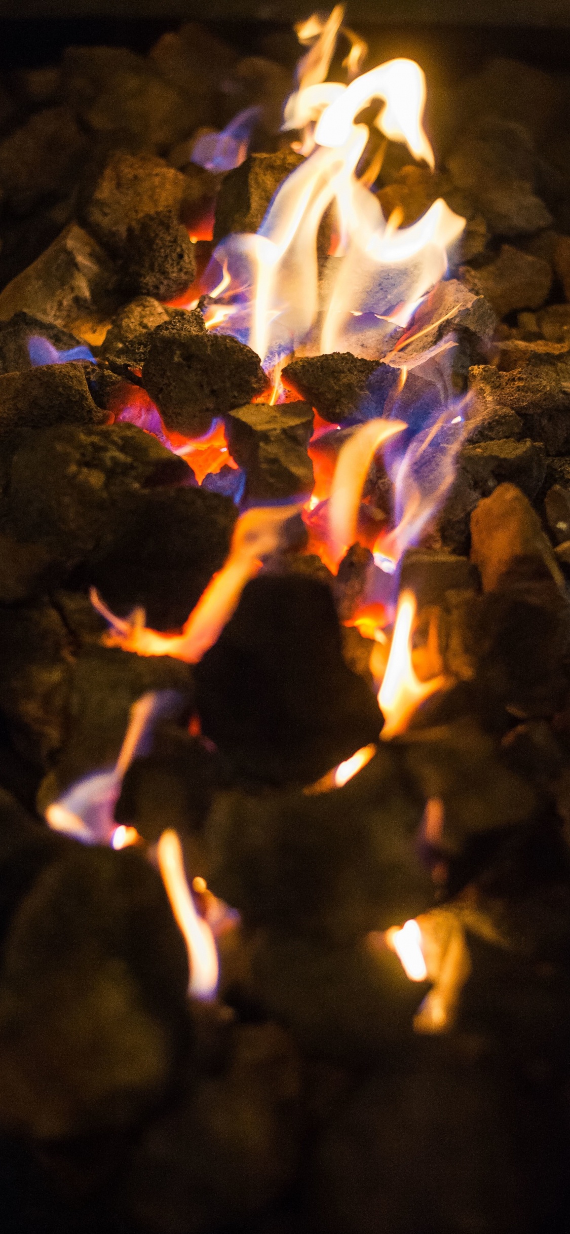 White and Brown Fire on Brown Rocks. Wallpaper in 1125x2436 Resolution
