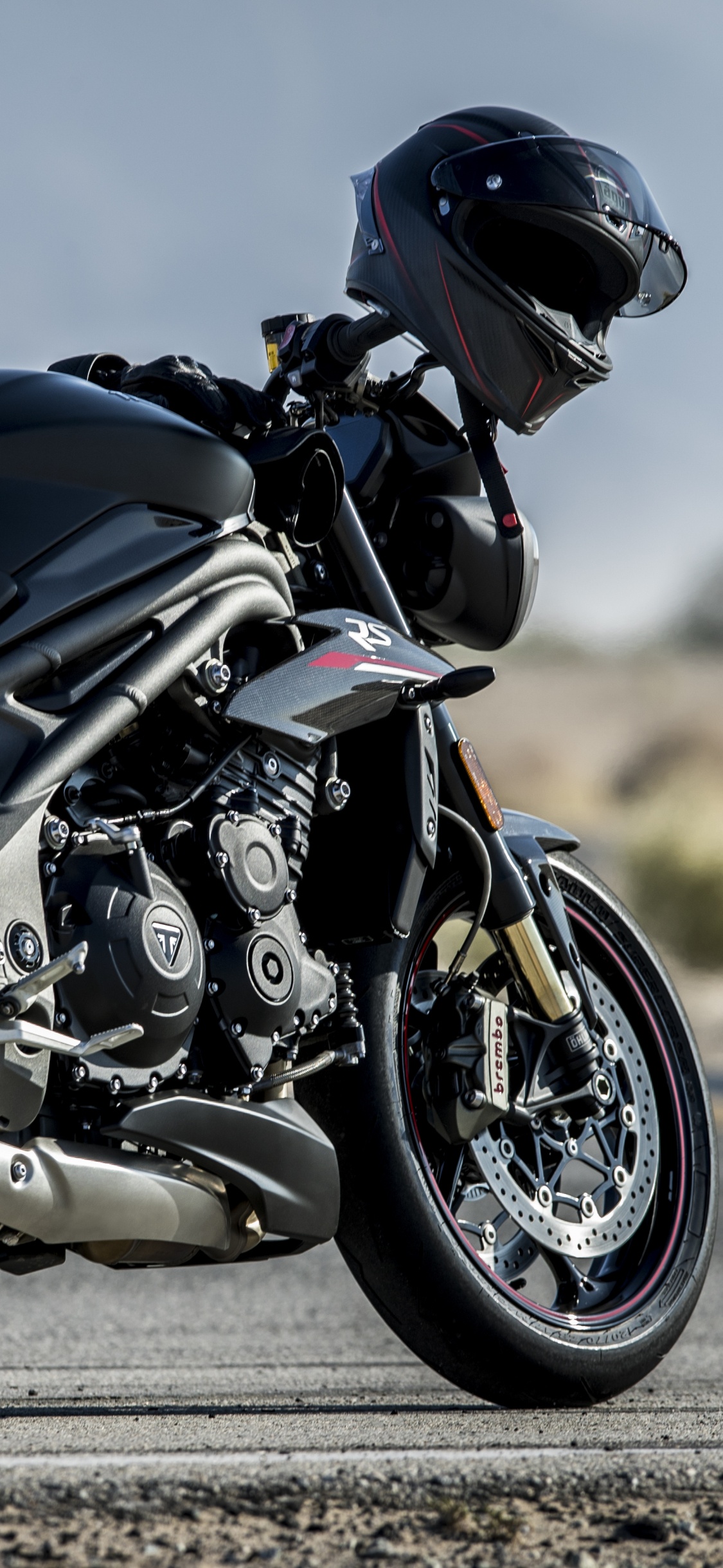 Man in Black Helmet Riding Black Sports Bike. Wallpaper in 1125x2436 Resolution