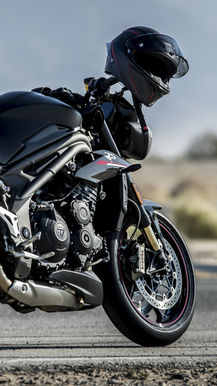 Man in Black Helmet Riding Black Sports Bike. Wallpaper in 750x1334 Resolution