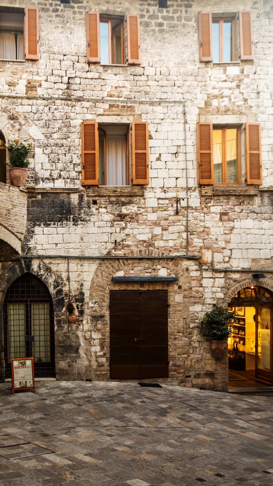 Brown Brick Building With Black Metal Gate. Wallpaper in 1080x1920 Resolution