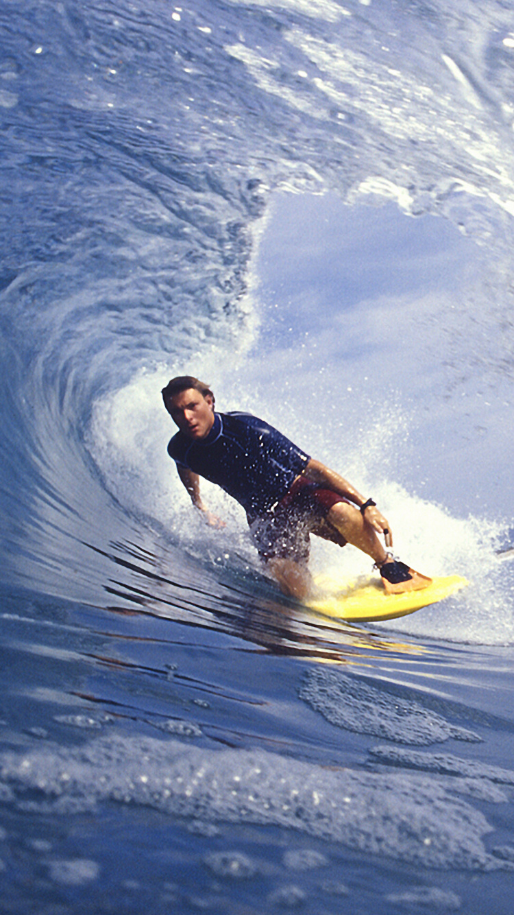 Man in Black Wetsuit Riding Yellow Surfboard on Blue Ocean Water During Daytime. Wallpaper in 750x1334 Resolution