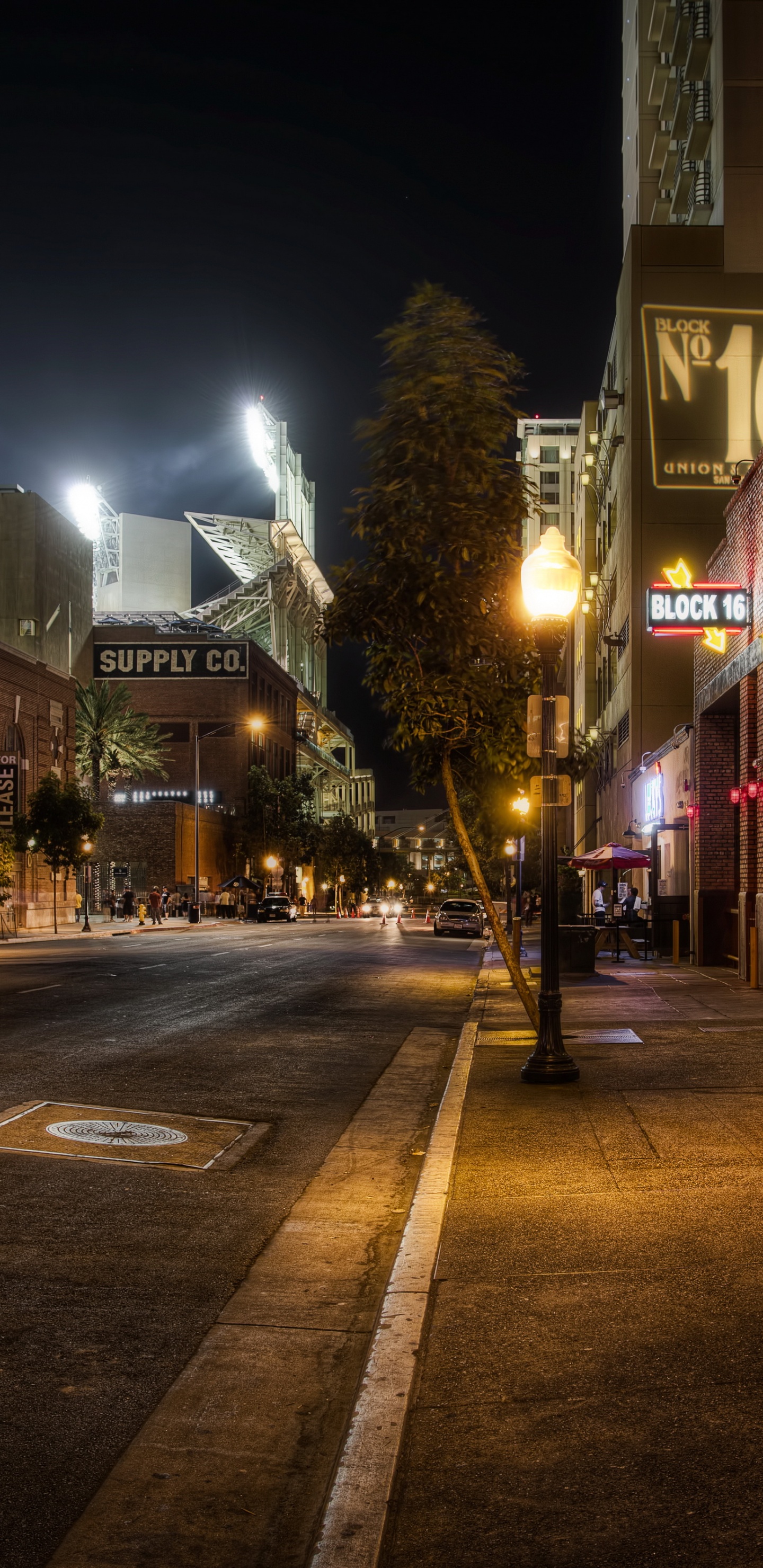Lighted Street Lights on The Street During Night Time. Wallpaper in 1440x2960 Resolution