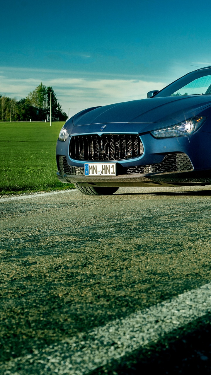 Blue Sedan on Gray Asphalt Road During Daytime. Wallpaper in 720x1280 Resolution