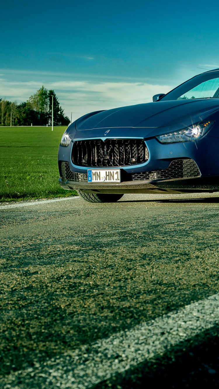 Blue Sedan on Gray Asphalt Road During Daytime. Wallpaper in 750x1334 Resolution