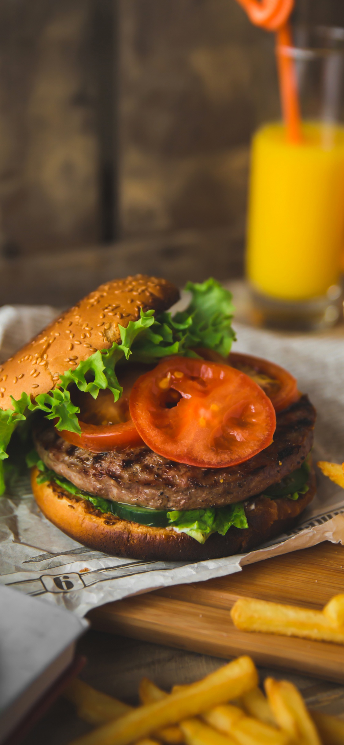 Burger Avec Laitue et Tomate Sur Papier Blanc. Wallpaper in 1125x2436 Resolution