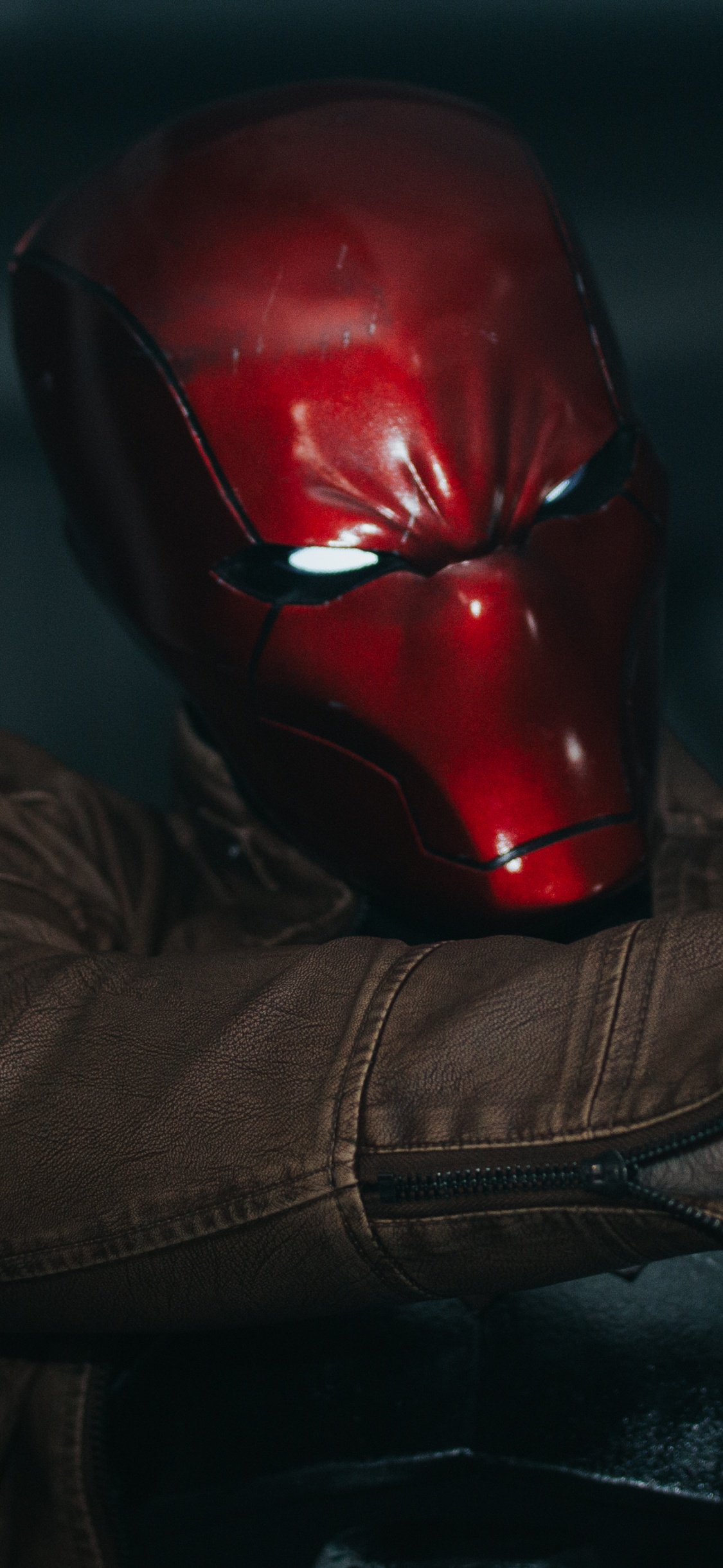 Person Wearing Red Helmet and Brown Jacket. Wallpaper in 1125x2436 Resolution
