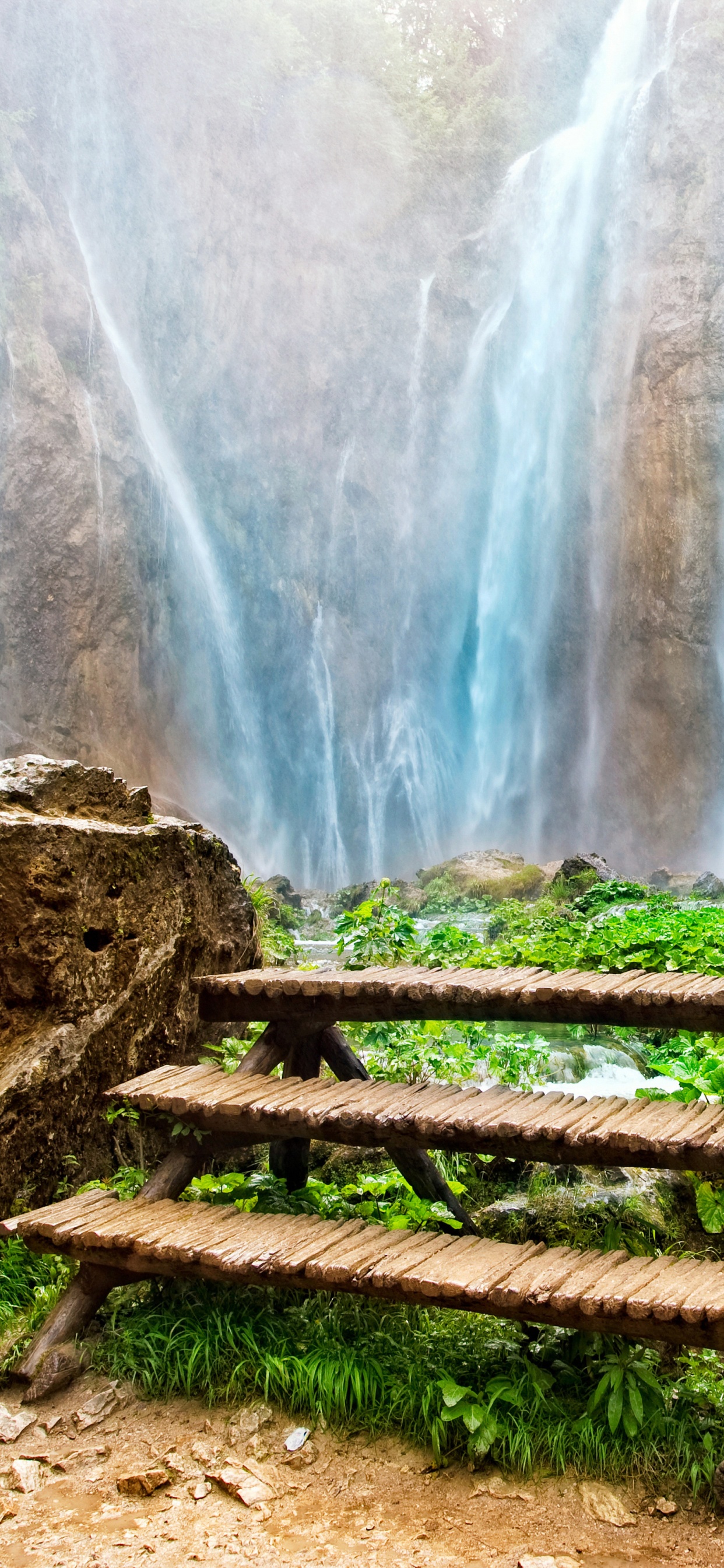 Brown Wooden Bench Near Waterfalls During Daytime. Wallpaper in 1242x2688 Resolution