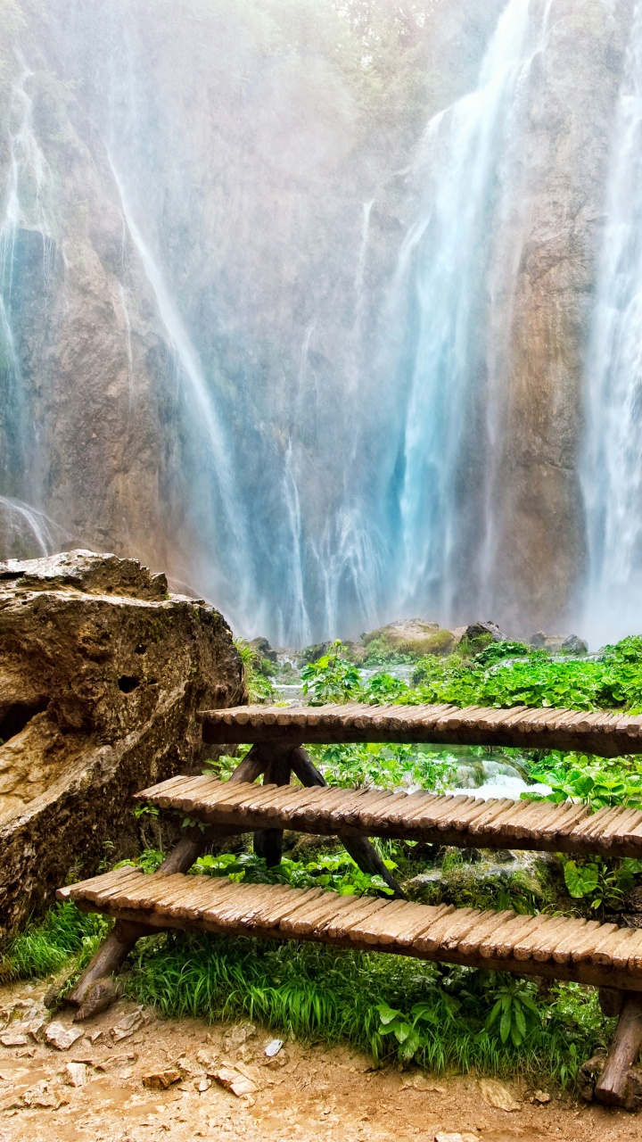 Brown Wooden Bench Near Waterfalls During Daytime. Wallpaper in 720x1280 Resolution