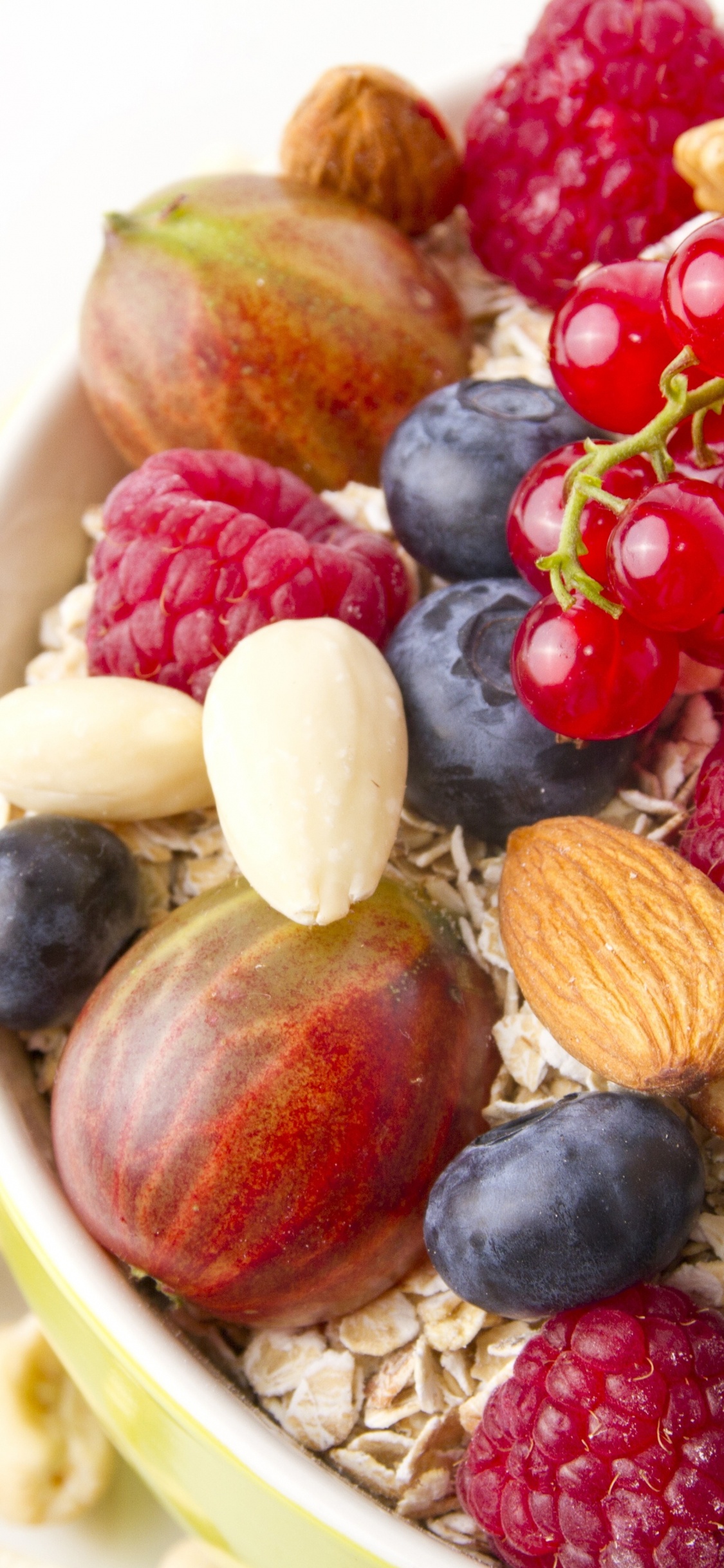 Red and Black Berries on White Ceramic Bowl. Wallpaper in 1125x2436 Resolution