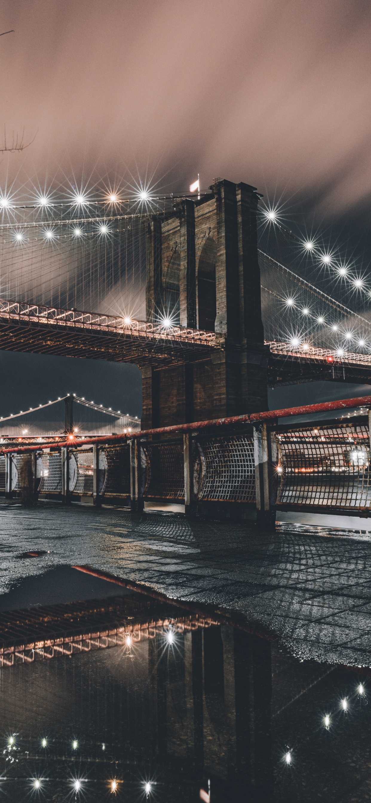 Brown Bridge Over Water During Night Time. Wallpaper in 1242x2688 Resolution