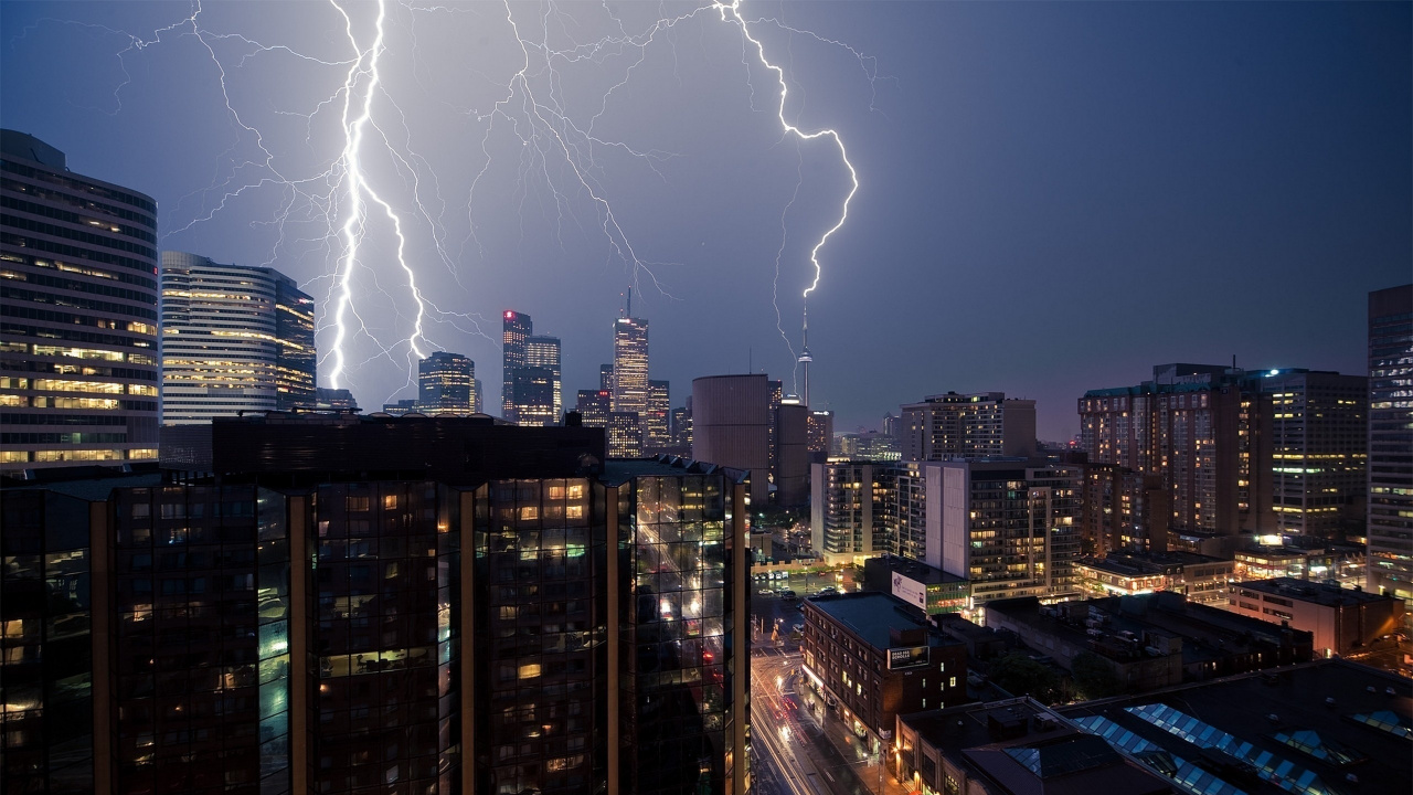 Lightning Over City Buildings During Night Time. Wallpaper in 1280x720 Resolution