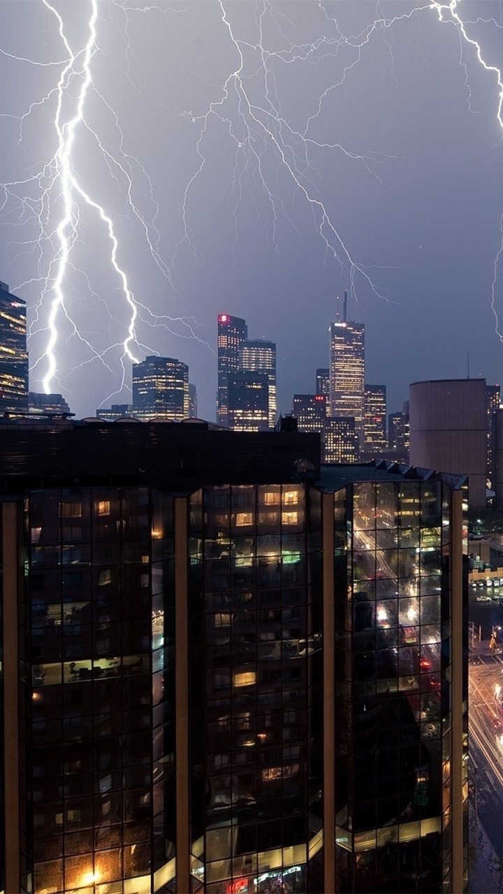 Lightning Over City Buildings During Night Time. Wallpaper in 720x1280 Resolution