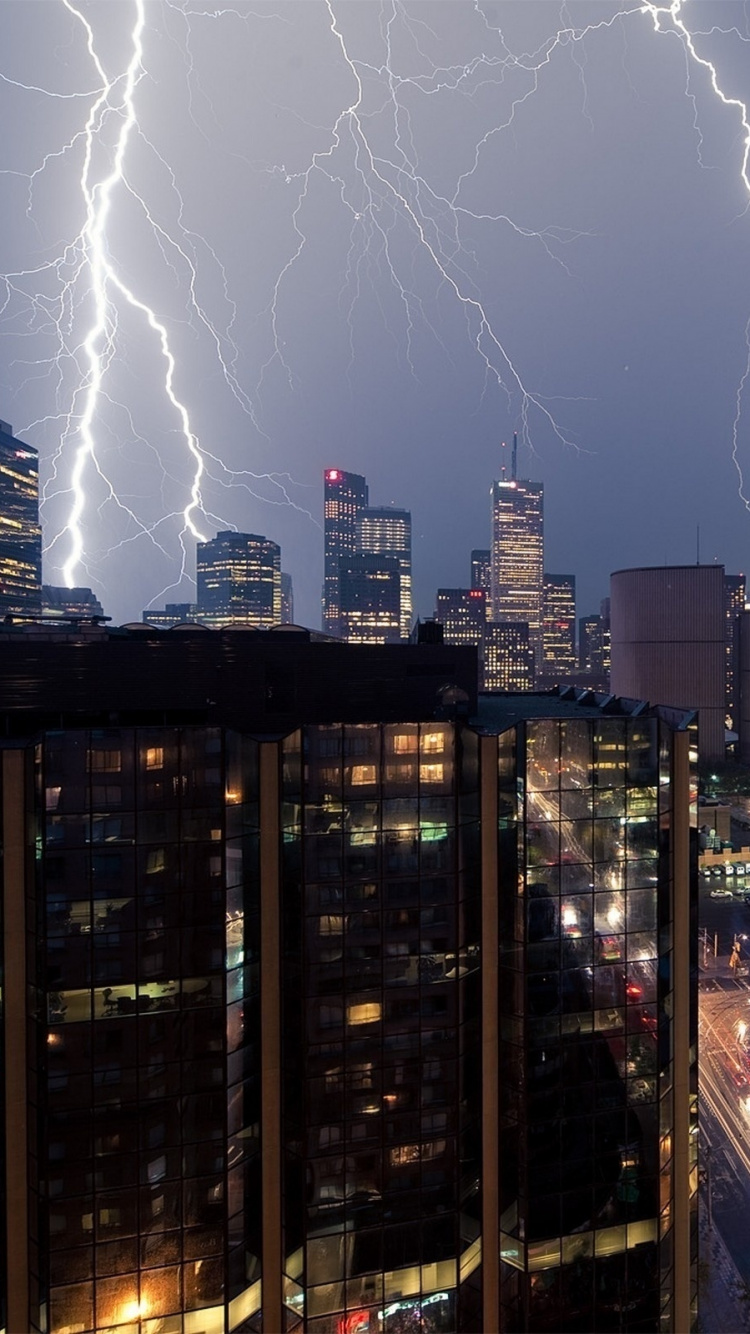Lightning Over City Buildings During Night Time. Wallpaper in 750x1334 Resolution