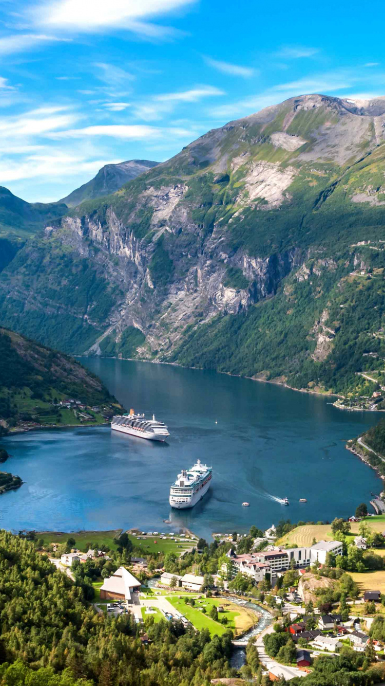 Green Mountains Near Body of Water Under Blue Sky During Daytime. Wallpaper in 750x1334 Resolution