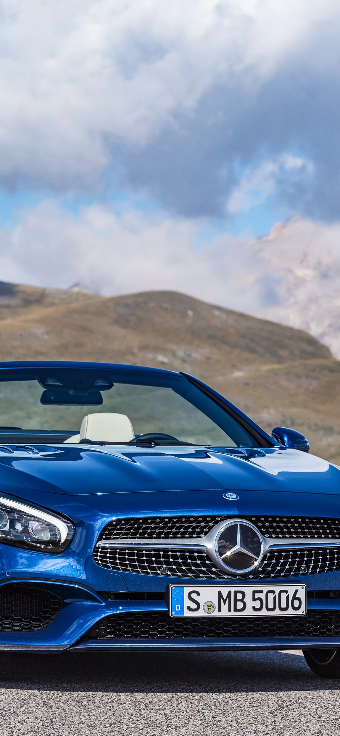 Blue Bmw m 3 on Brown Field Under White Clouds and Blue Sky During Daytime. Wallpaper in 1125x2436 Resolution