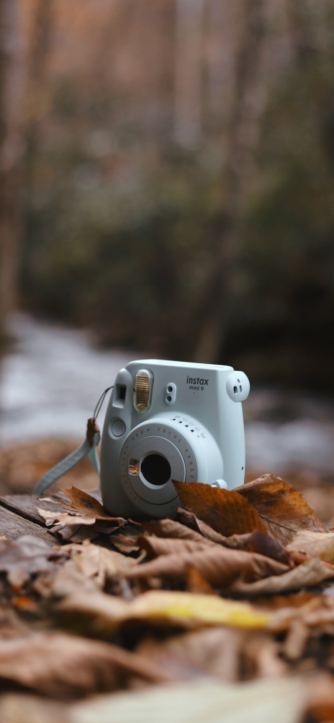 White and Silver Point and Shoot Camera on Brown Wooden Table. Wallpaper in 1125x2436 Resolution
