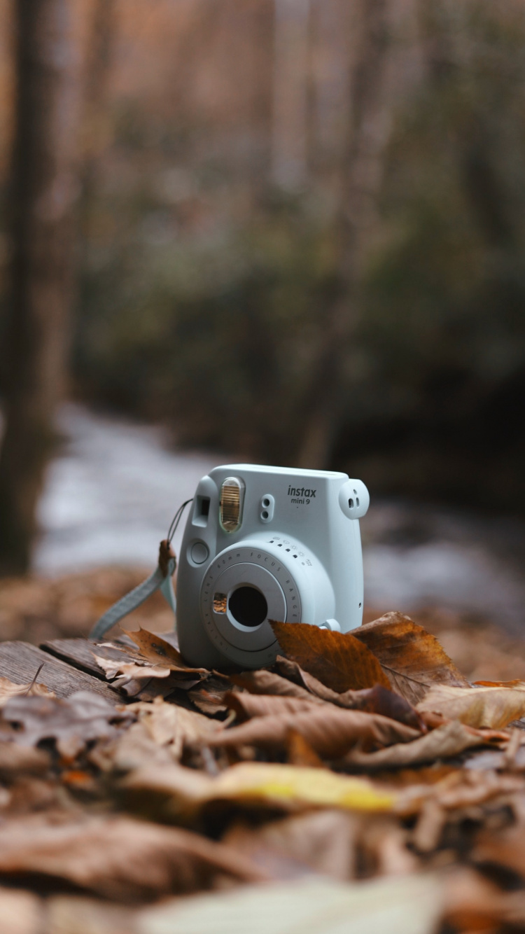 White and Silver Point and Shoot Camera on Brown Wooden Table. Wallpaper in 750x1334 Resolution
