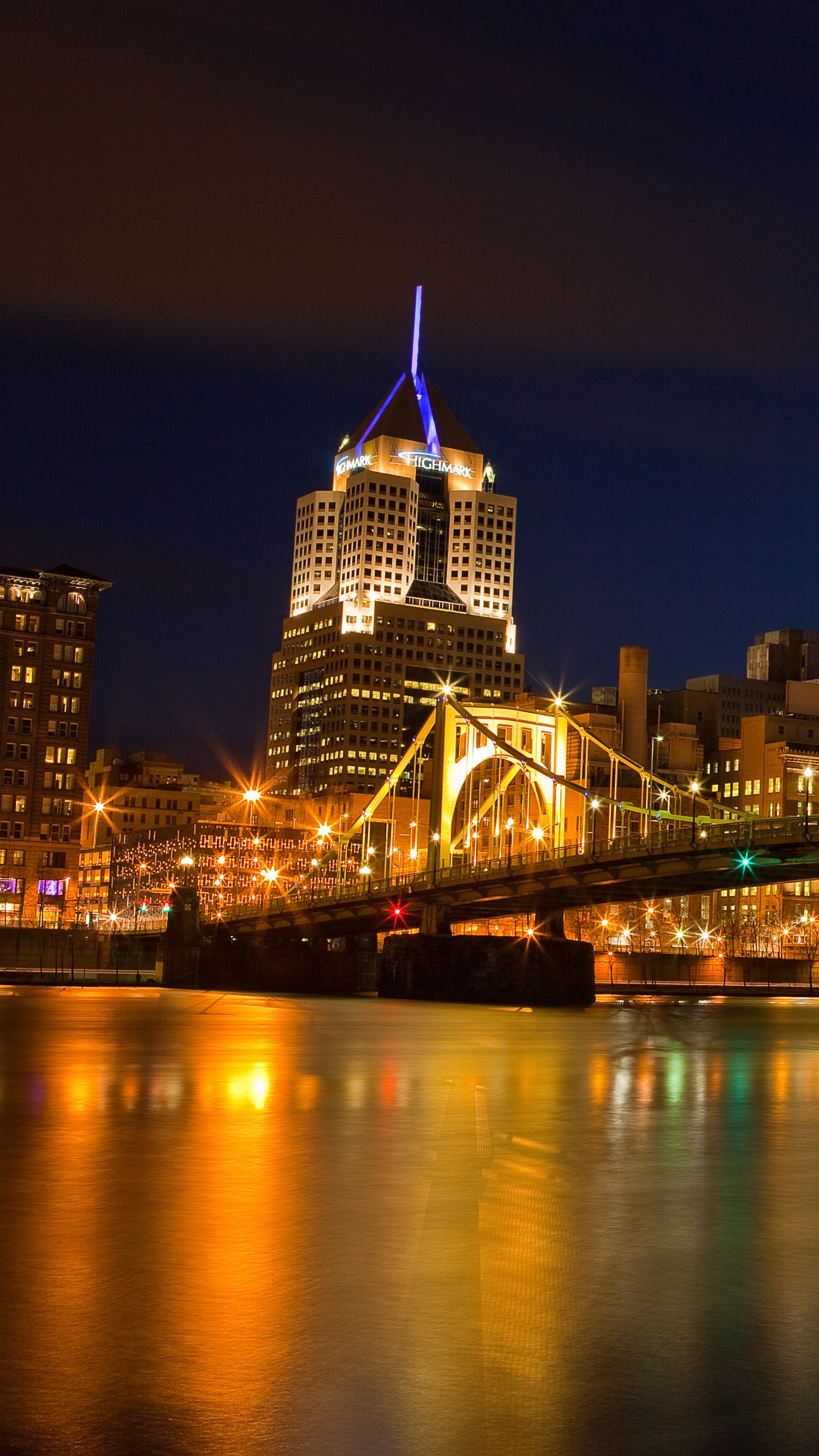 Lighted Bridge Over Water During Night Time. Wallpaper in 1440x2560 Resolution