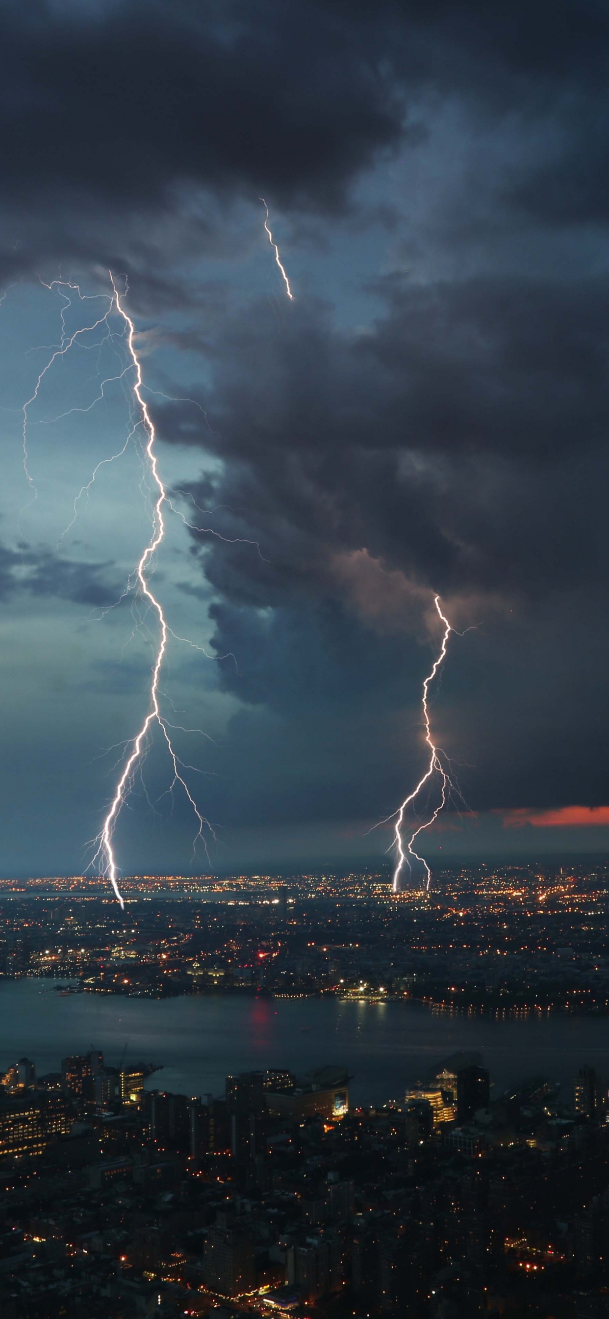 City Skyline Under White Clouds. Wallpaper in 1242x2688 Resolution