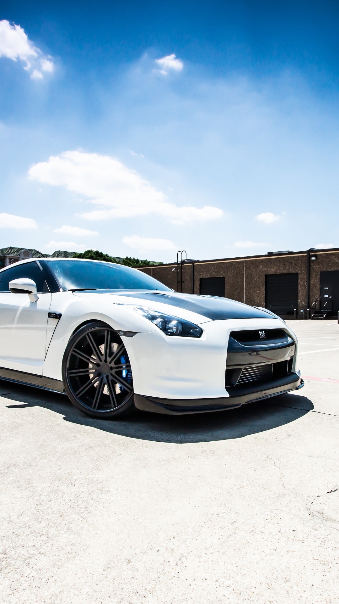 White Coupe Parked on Gray Concrete Floor During Daytime. Wallpaper in 1080x1920 Resolution