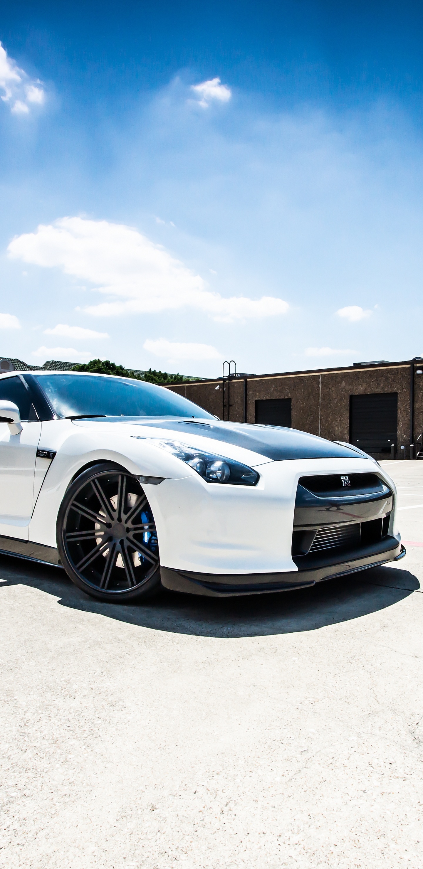 White Coupe Parked on Gray Concrete Floor During Daytime. Wallpaper in 1440x2960 Resolution