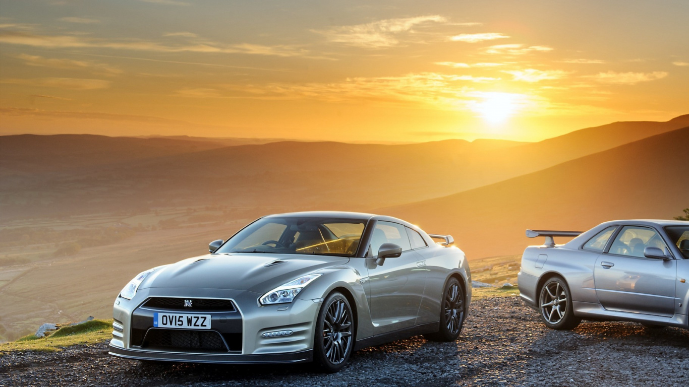 Porsche 911 Plateado Sobre Arena Negra Durante la Puesta de Sol. Wallpaper in 1366x768 Resolution