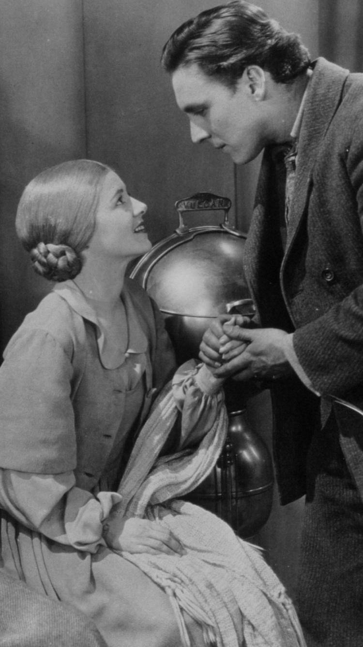 Homme en Veste de Costume Noir Assis à Côté D'une Femme en Robe Grise. Wallpaper in 750x1334 Resolution