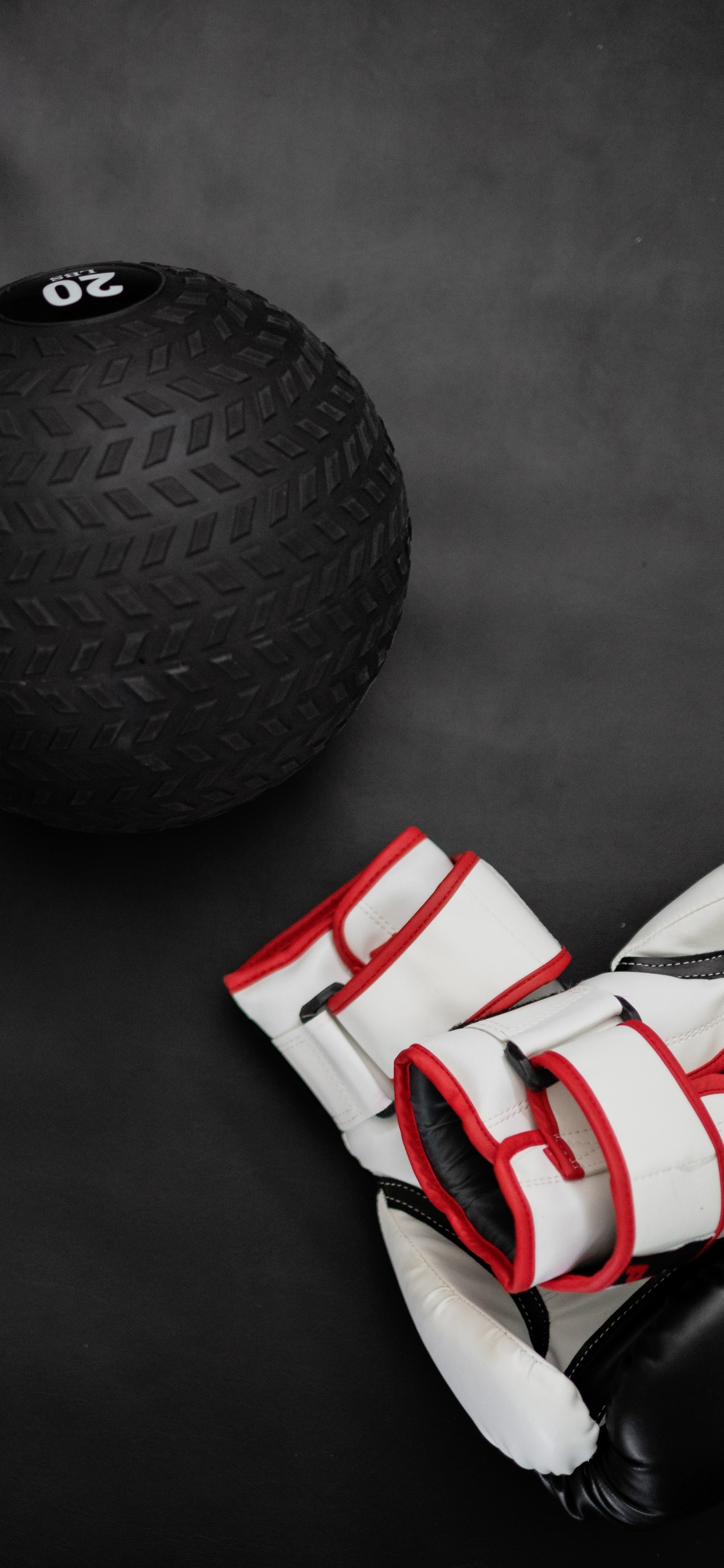 White and Red Soccer Ball Beside Black Ball. Wallpaper in 1125x2436 Resolution