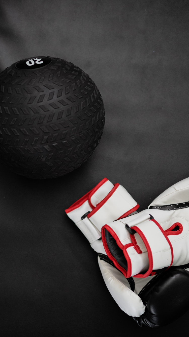 White and Red Soccer Ball Beside Black Ball. Wallpaper in 750x1334 Resolution