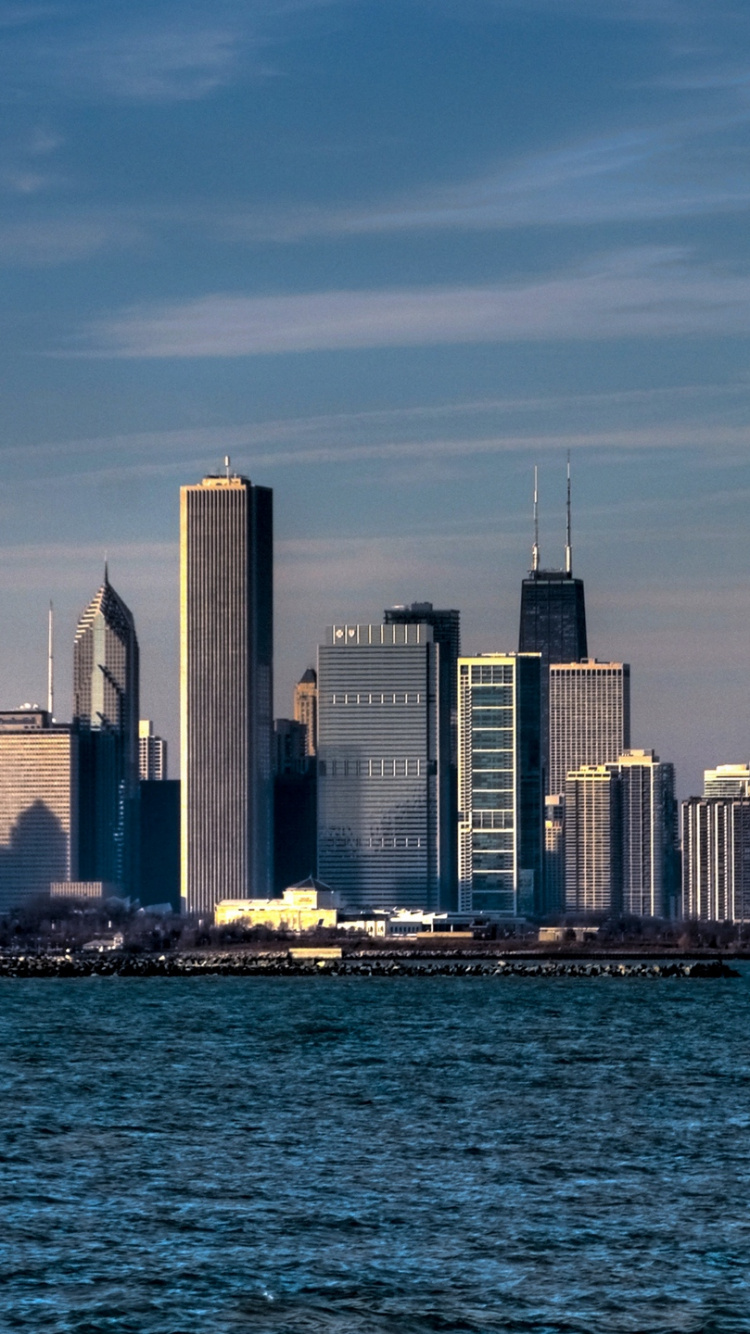 City Skyline Across Body of Water During Daytime. Wallpaper in 750x1334 Resolution