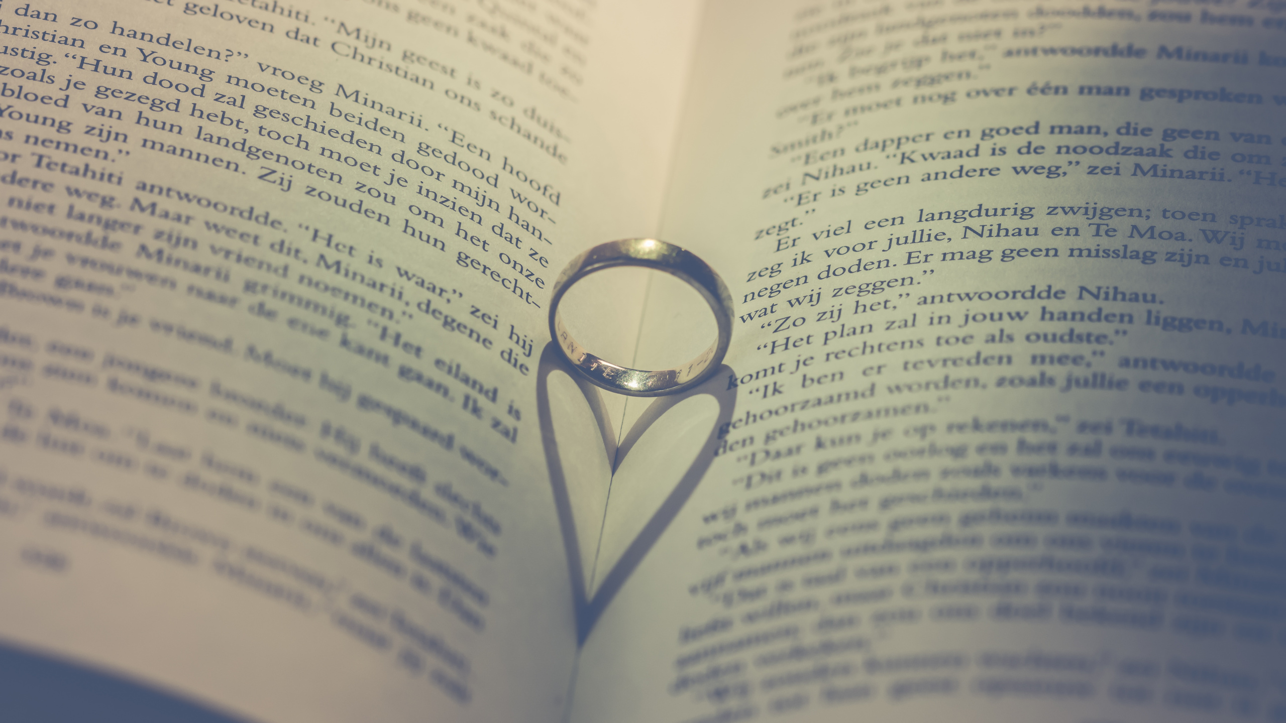 Silver Ring on Book Page. Wallpaper in 2560x1440 Resolution