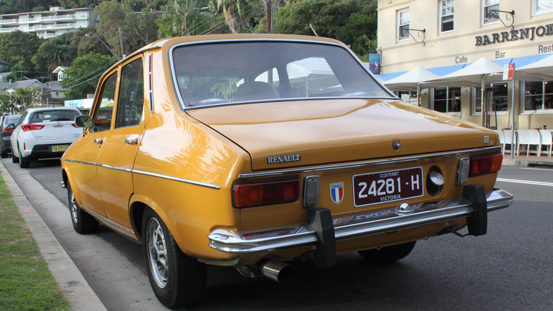 Yellow Sedan Parked on The Side of The Road. Wallpaper in 1920x1080 Resolution