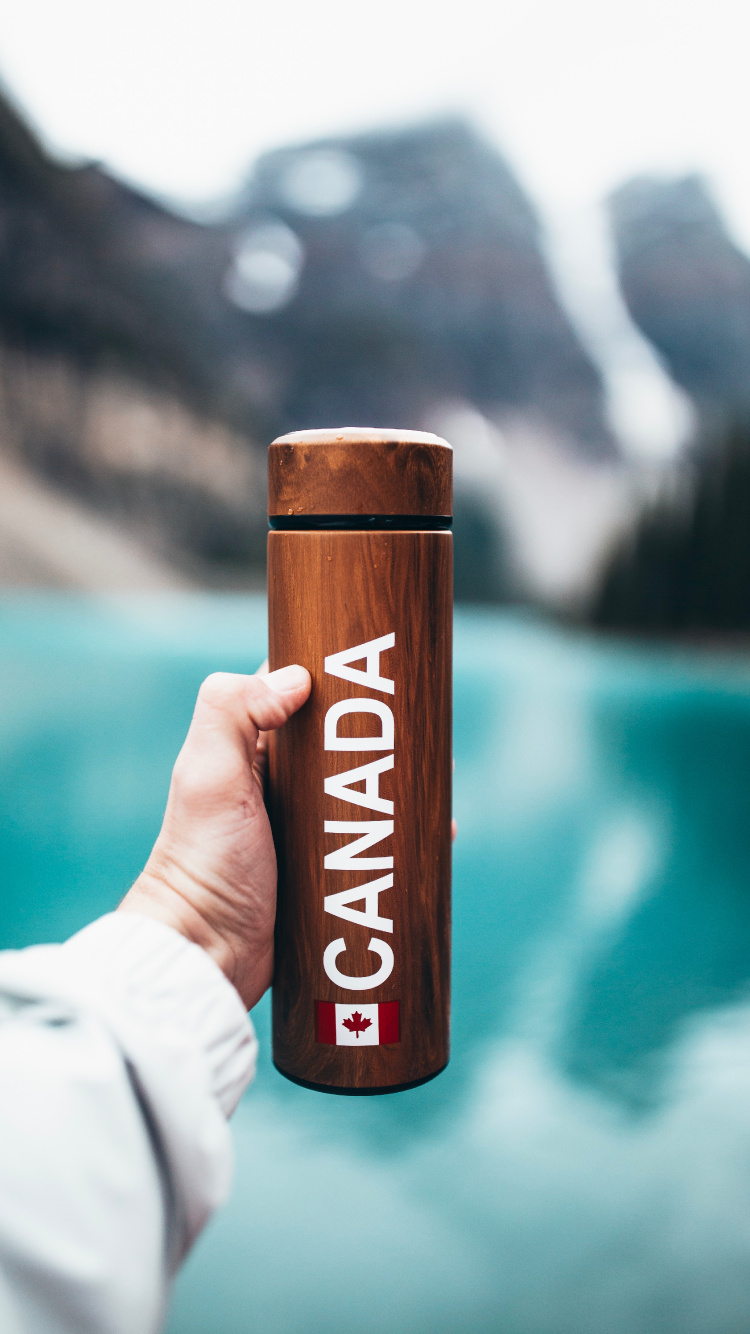 Person Holding Brown Wooden Bar. Wallpaper in 750x1334 Resolution