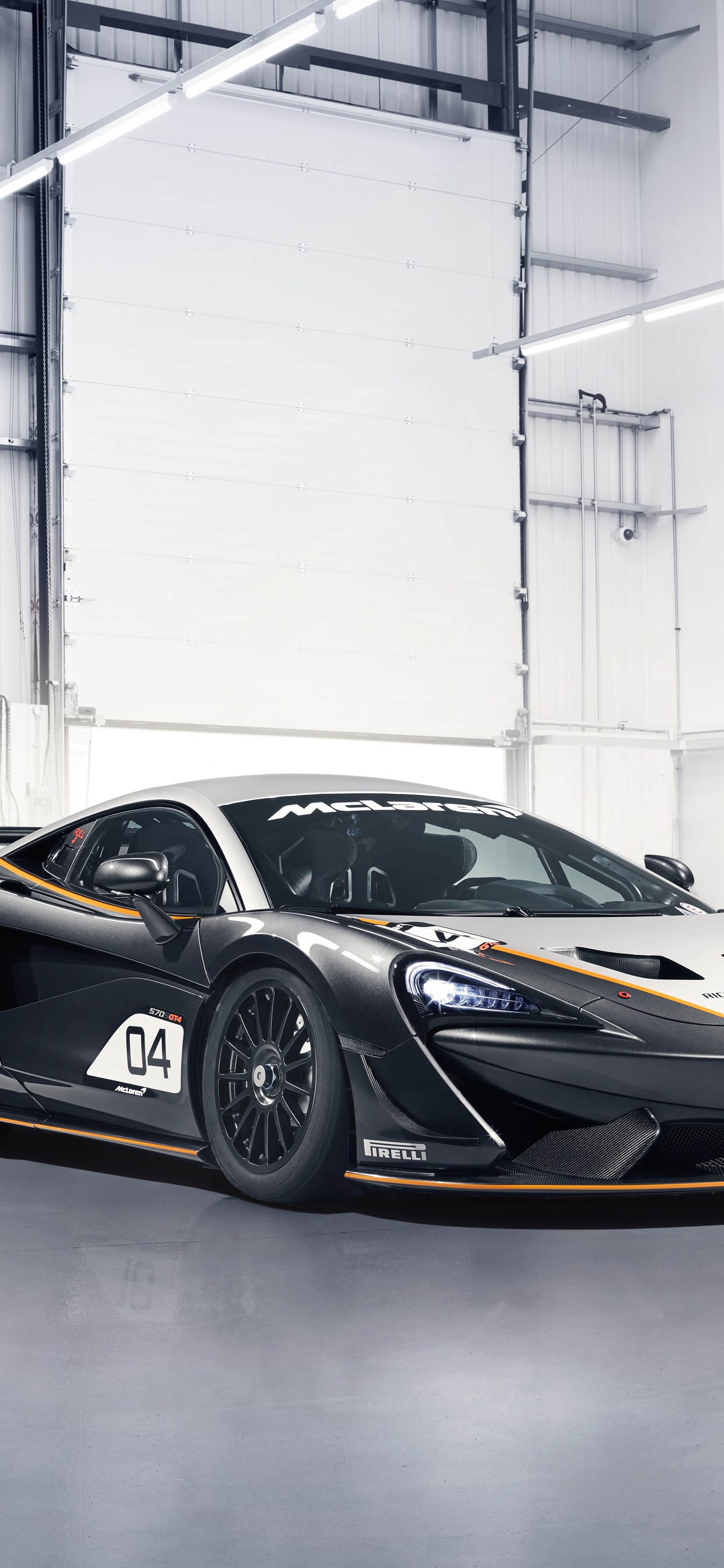 Black and White Porsche 911 Parked in a Garage. Wallpaper in 1242x2688 Resolution