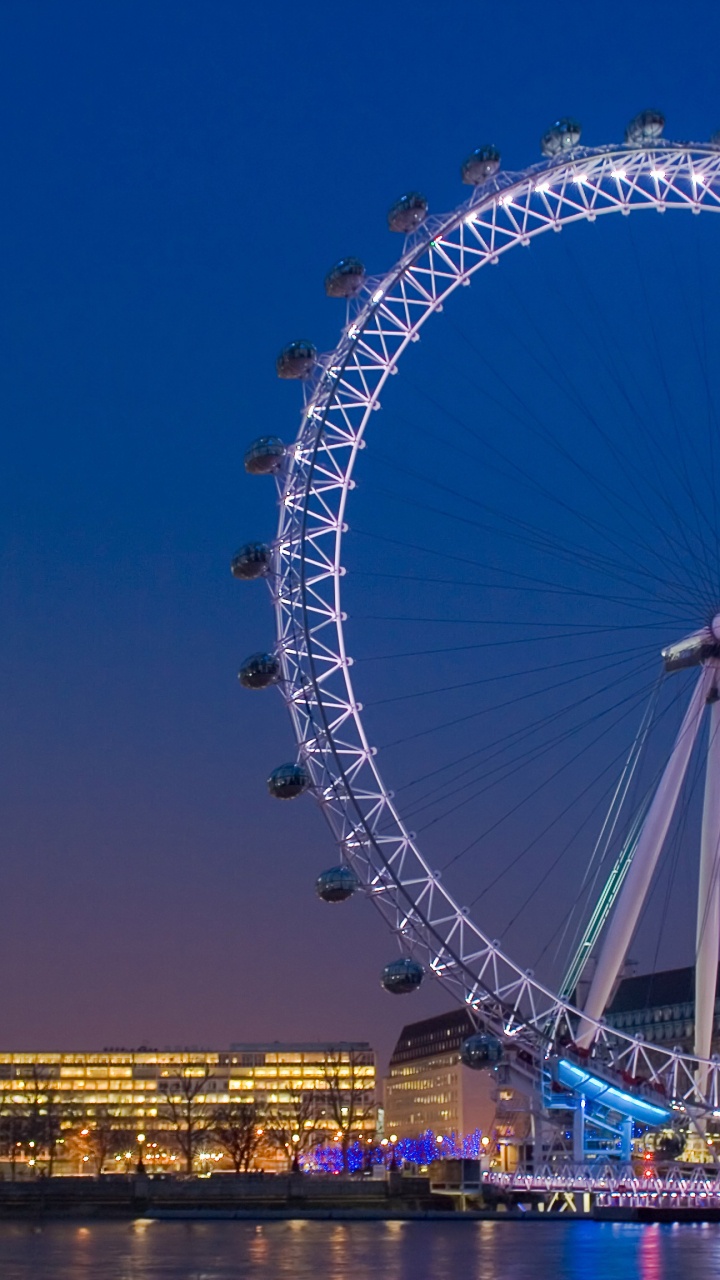 Ferris Wheel Near City Buildings During Night Time. Wallpaper in 720x1280 Resolution