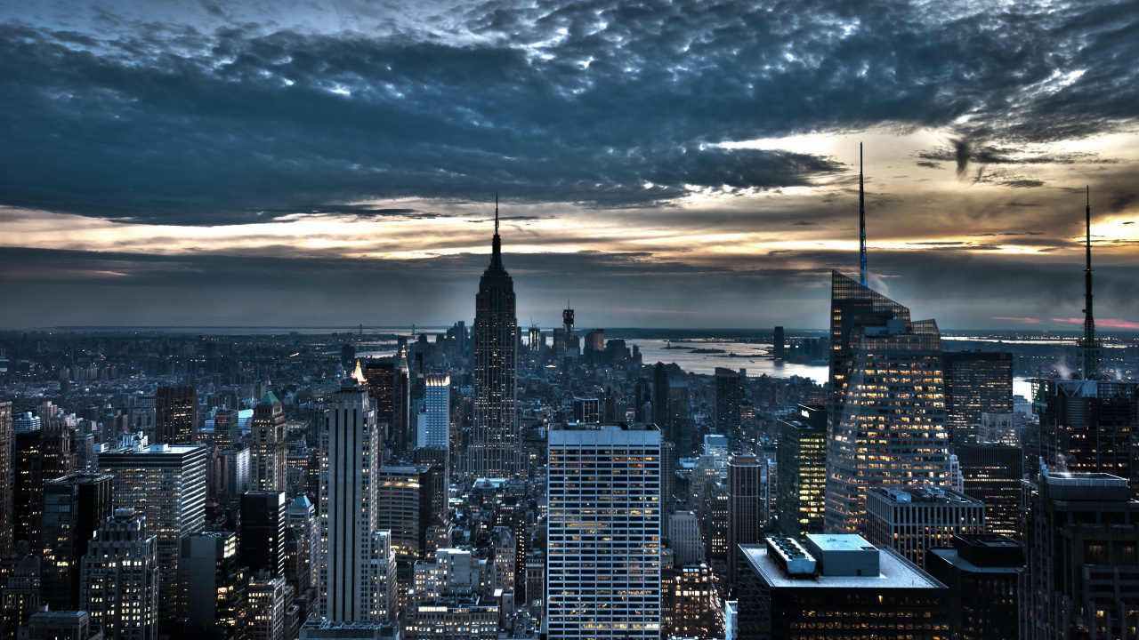 City Skyline Under Cloudy Sky During Night Time. Wallpaper in 1280x720 Resolution