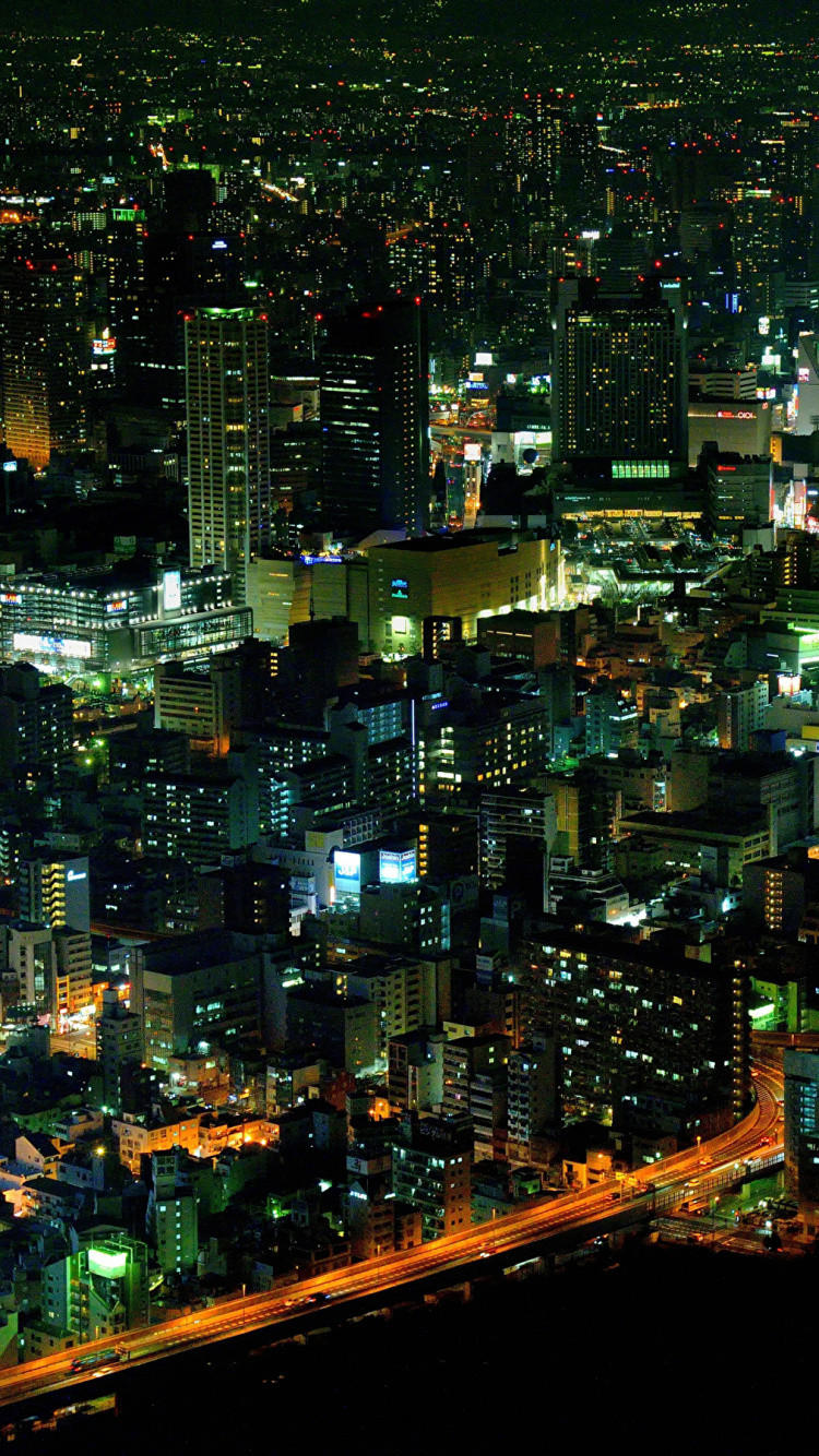 Vista Aérea de Los Edificios de la Ciudad Durante la Noche.. Wallpaper in 750x1334 Resolution