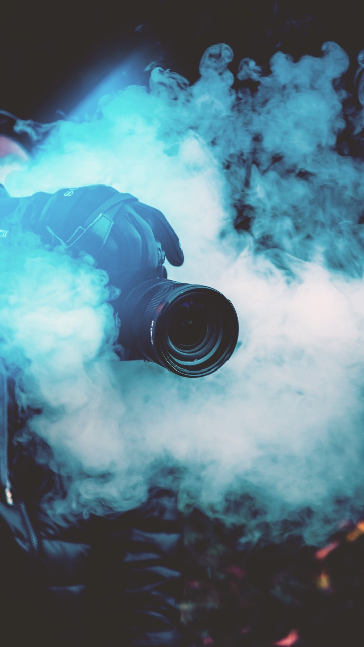 Black Dslr Camera on Blue Smoke. Wallpaper in 720x1280 Resolution