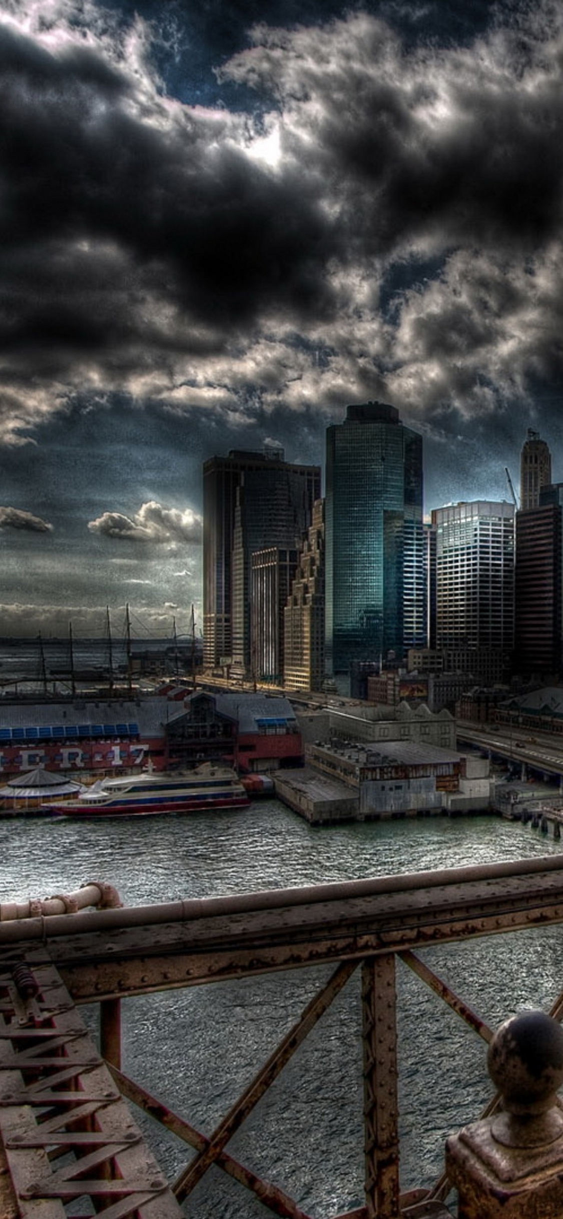 City Skyline Under Cloudy Sky During Daytime. Wallpaper in 1125x2436 Resolution