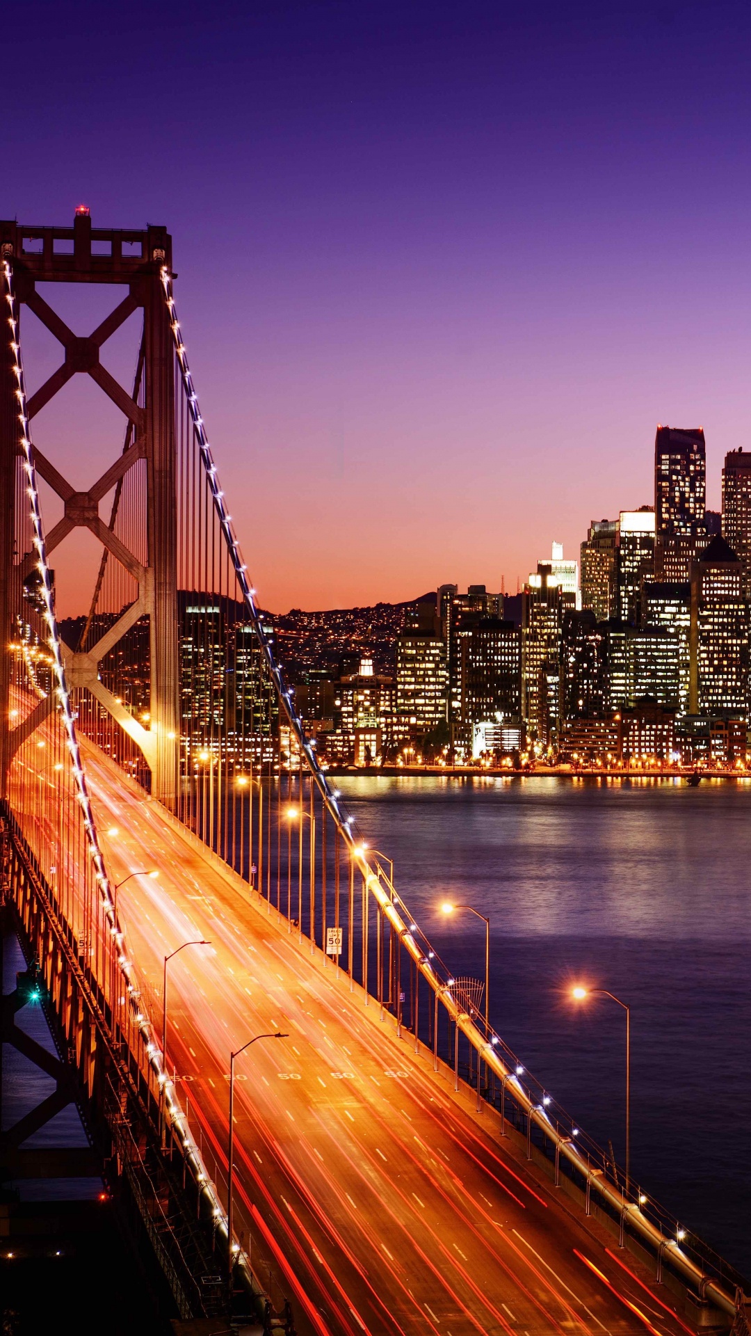 Bridge Over Water Near City Buildings During Night Time. Wallpaper in 1080x1920 Resolution