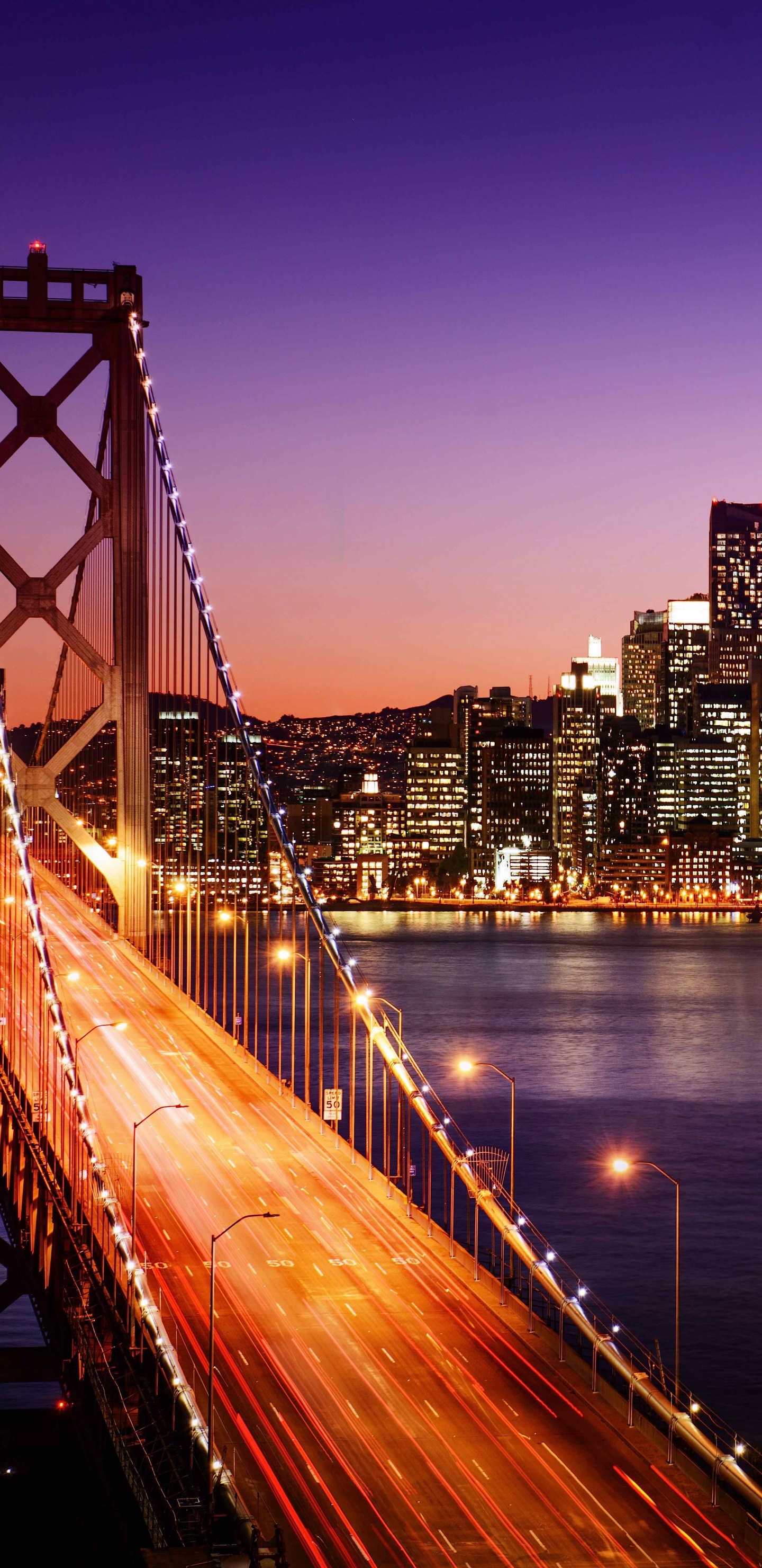 Bridge Over Water Near City Buildings During Night Time. Wallpaper in 1440x2960 Resolution