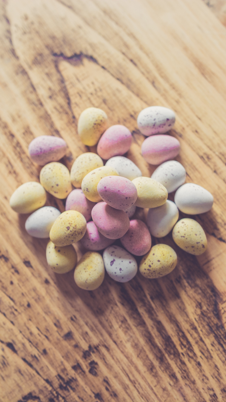 Pink and White Heart Shaped Candies on Brown Wooden Table. Wallpaper in 750x1334 Resolution