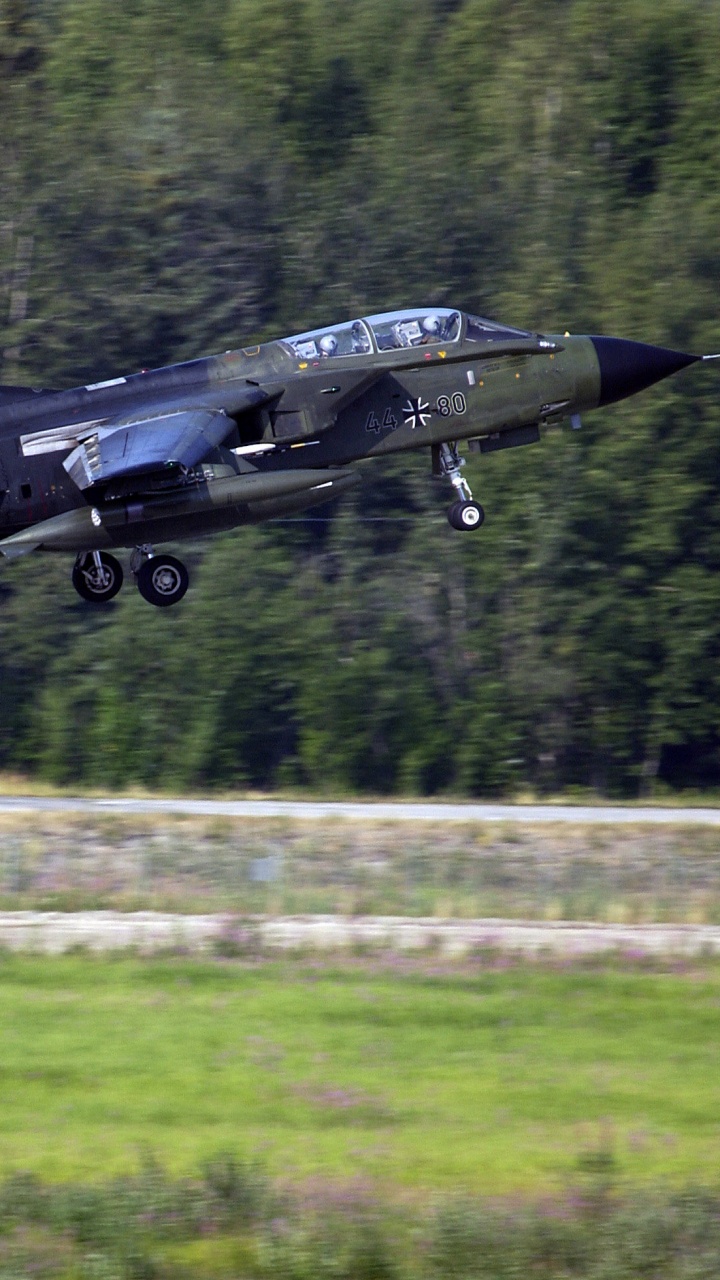Black Jet Plane Flying Over Green Grass Field During Daytime. Wallpaper in 720x1280 Resolution