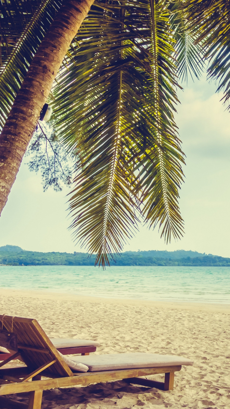 Brown Wooden Lounge Chair on Beach During Daytime. Wallpaper in 750x1334 Resolution