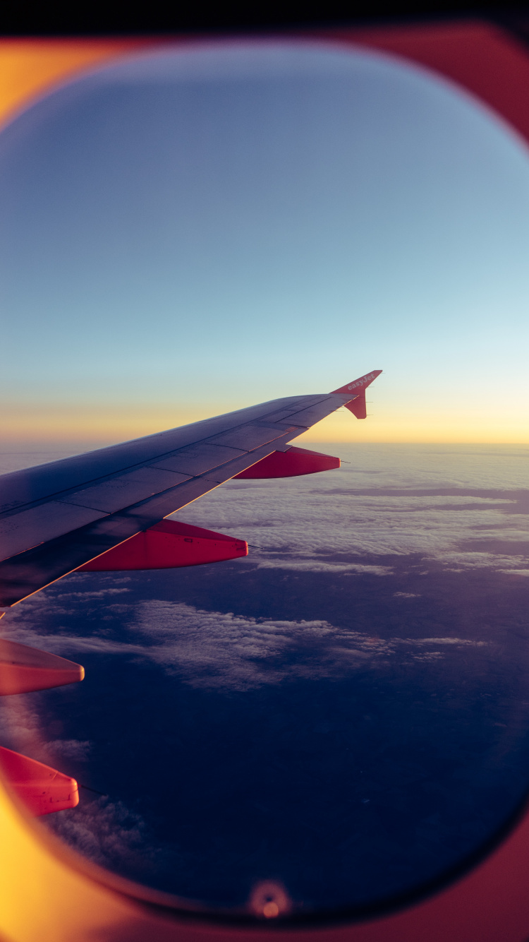 Ala de Avión Blanca y Roja Durante el Día. Wallpaper in 750x1334 Resolution