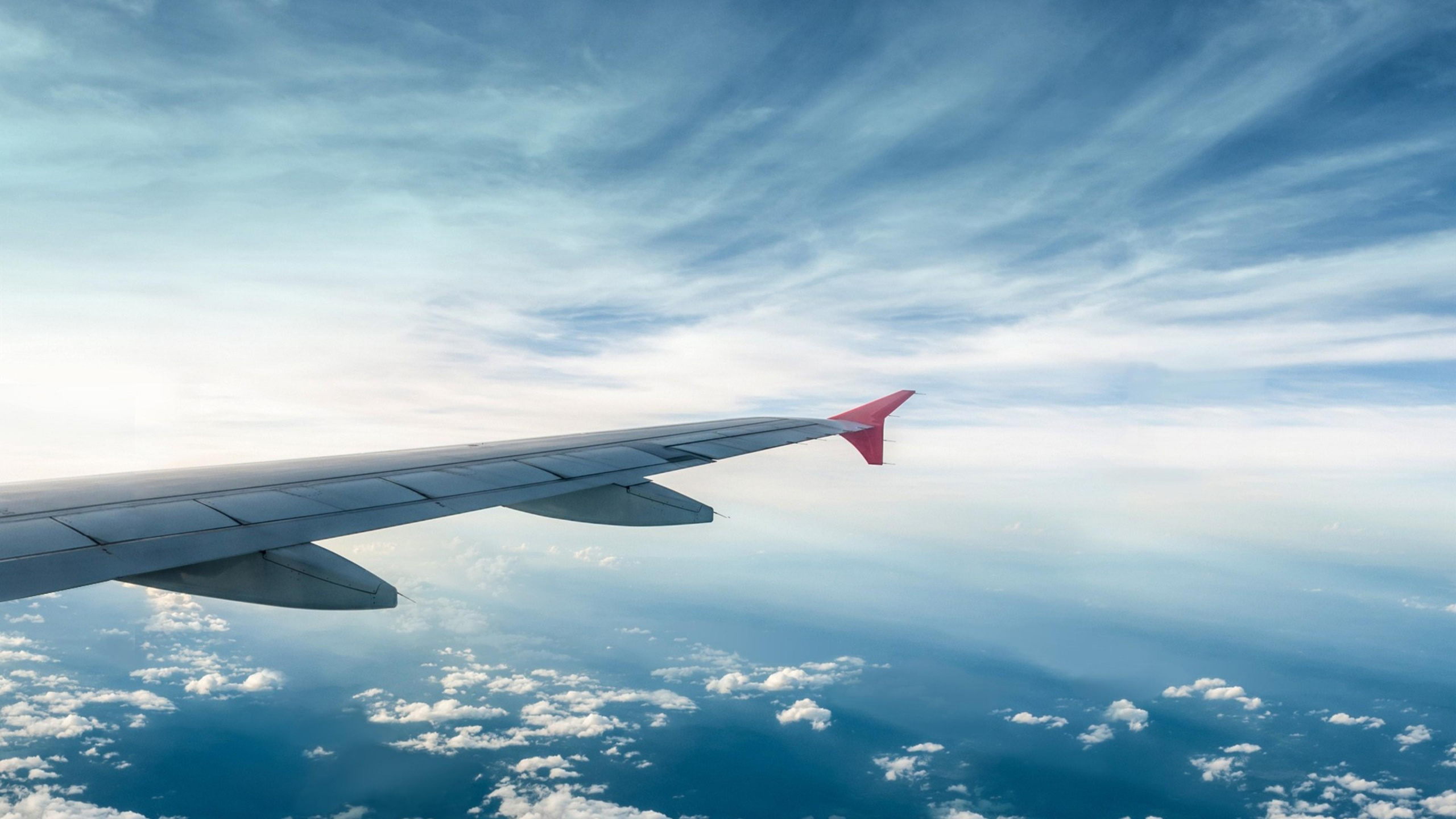 White and Red Airplane Wing Under Blue Sky and White Clouds During Daytime. Wallpaper in 2560x1440 Resolution