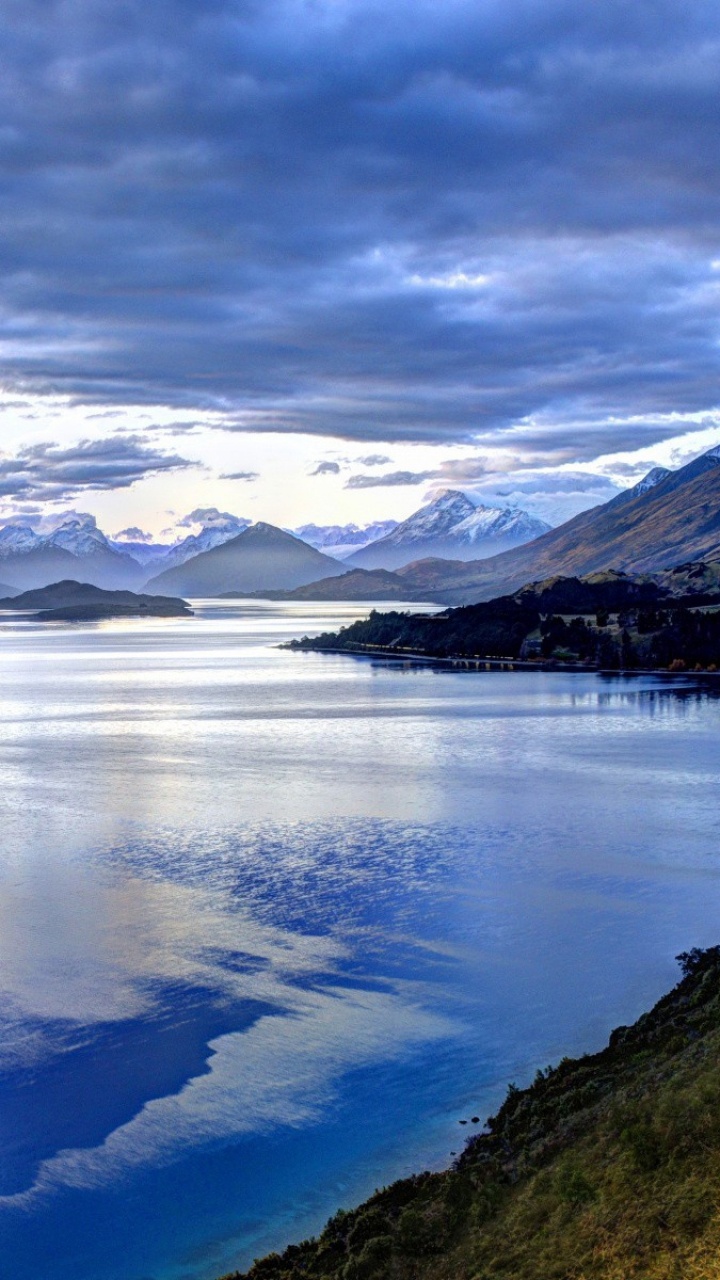 Lake in The Middle of Mountains Under White Clouds and Blue Sky. Wallpaper in 720x1280 Resolution