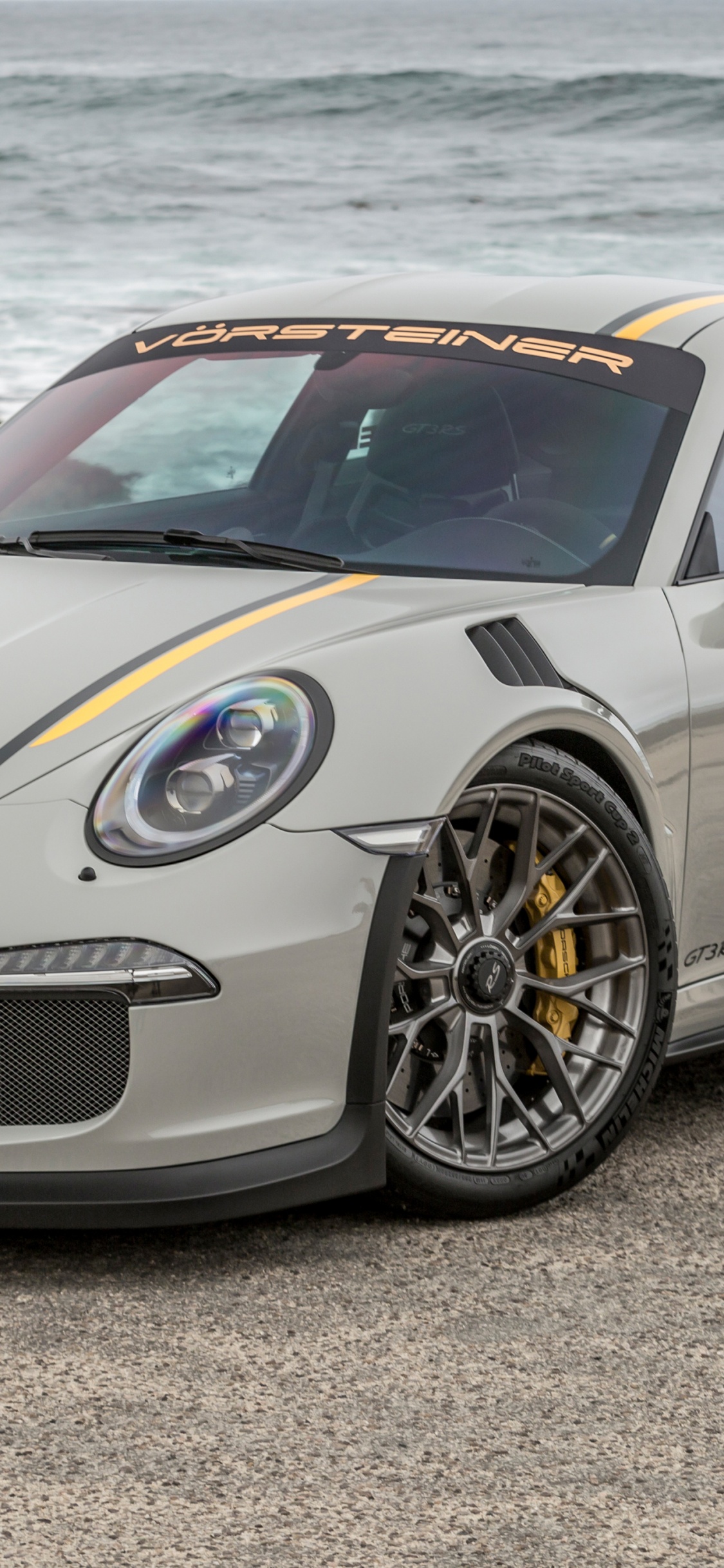 White Mercedes Benz Coupe on Gray Sand During Daytime. Wallpaper in 1125x2436 Resolution