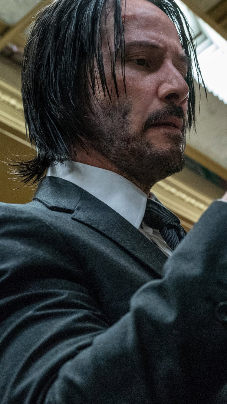 Man in Black Suit Holding White Paper. Wallpaper in 750x1334 Resolution