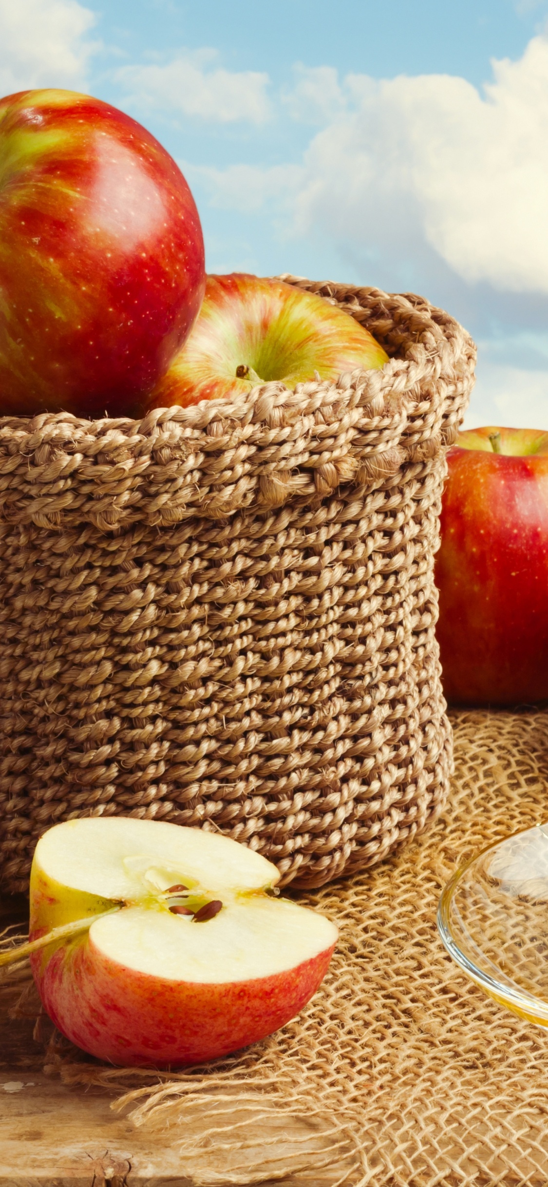 Red Apples on Brown Woven Basket. Wallpaper in 1125x2436 Resolution